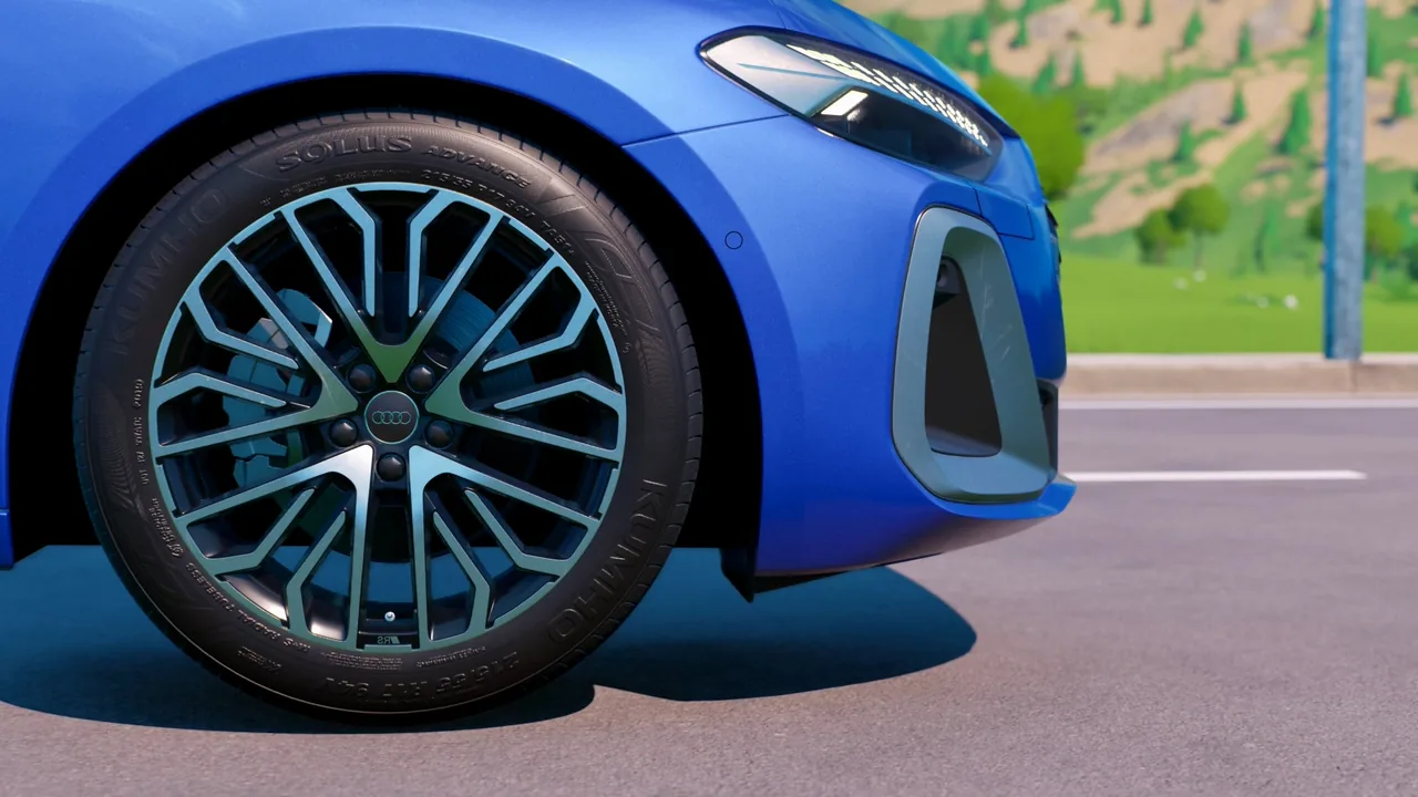 CG close-up of a blue Audi’s front wheel with visible Kumho Solus sidewall lettering